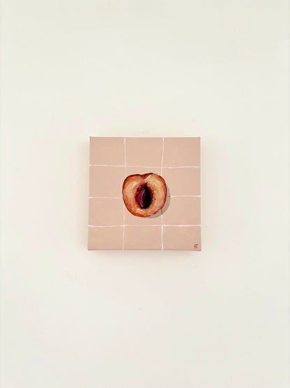 Painted halved peach on pale peach tiled background.