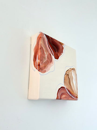 Painting of abstract flowers. Petals are warm browns and pinks and are placed in two corners of the canvas and wrap around the side of it. 