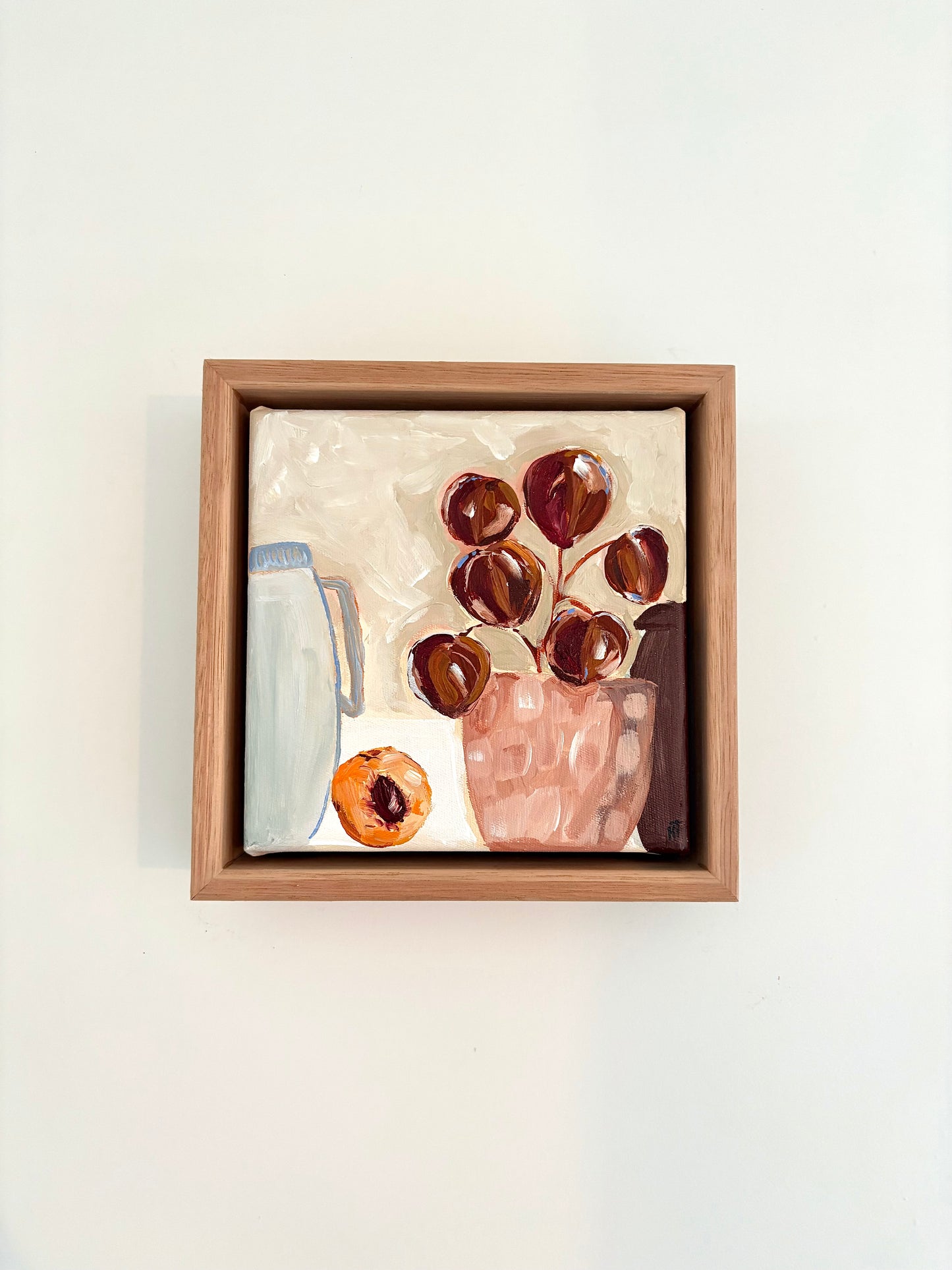Abstract still life painting with a plant in pink pot, halved peach and a pale blue jug.