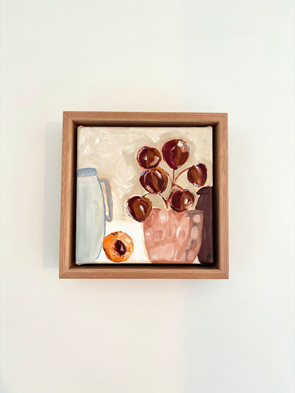 Abstract still life painting with a plant in pink pot, halved peach and a pale blue jug.