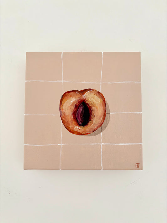 Painted halved peach on pale peach tiled background.