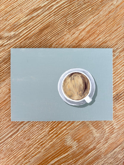 Painting of a coffee in a cup on a saucer with a muted teal  background