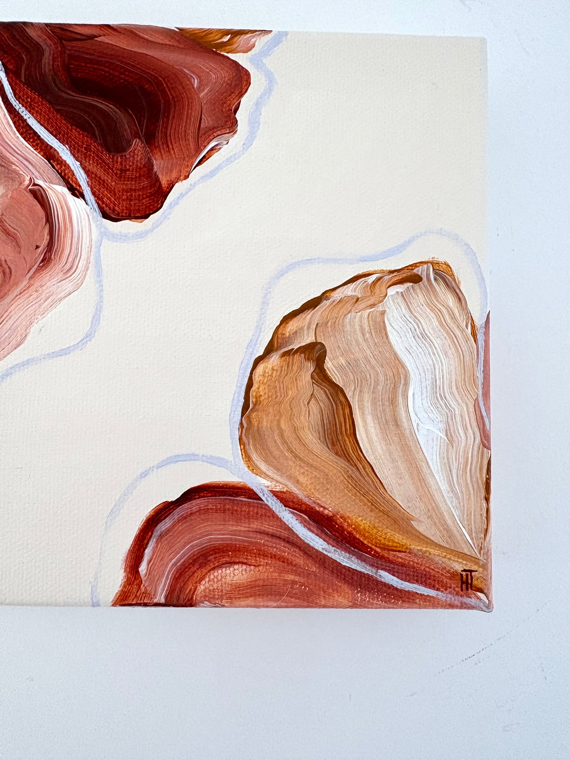 Painting of abstract flowers. Petals are warm browns and pinks and are placed in two corners of the canvas and wrap around the side of it. 