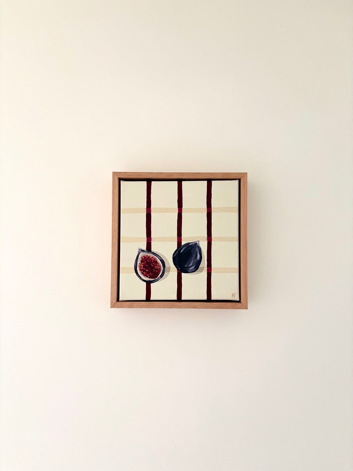 Painting of a halved dark fig on a cream checkered background with burgundy lines.