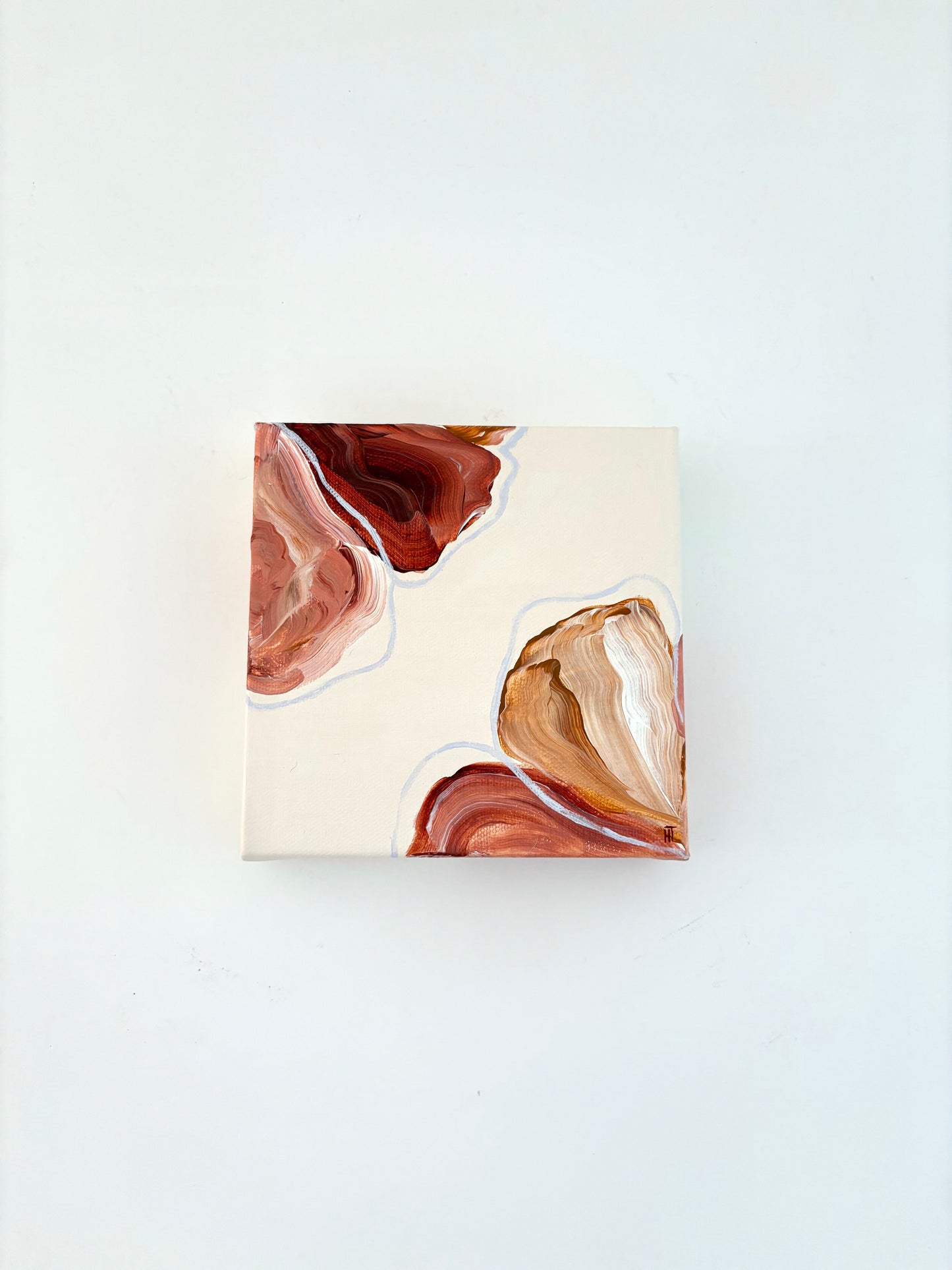 Painting of abstract flowers. Petals are warm browns and pinks and are placed in two corners of the canvas and wrap around the side of it. 