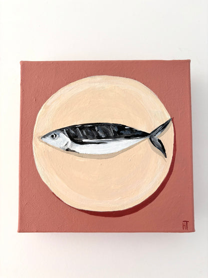 Painting of a fish on a beige circle plate with a dusty pink background.